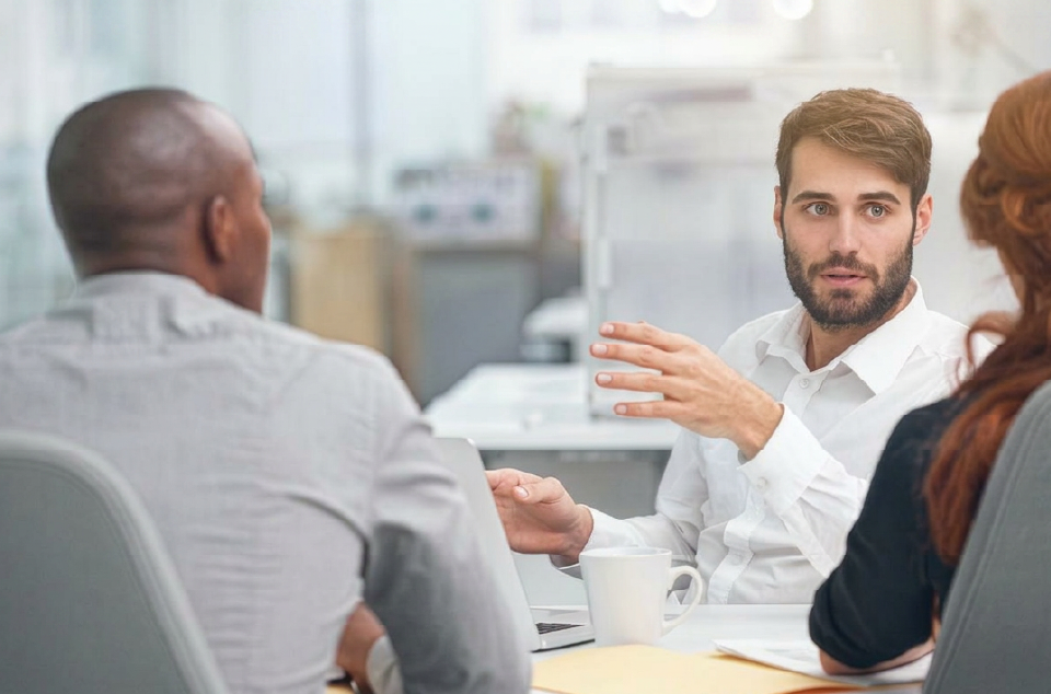 Executives concierge sent in an executive to manage a business meeting and he is meeting with two associates. 